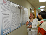 student in front of her poster