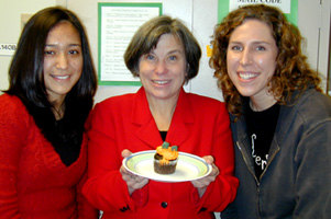 Dr. Smith holding a cupcake on a plate
