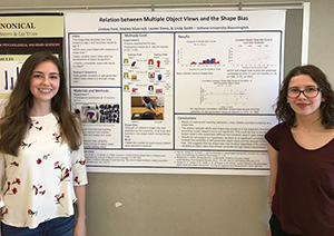2 students in front of their poster