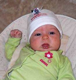 infant wearing looxcie attached to cap