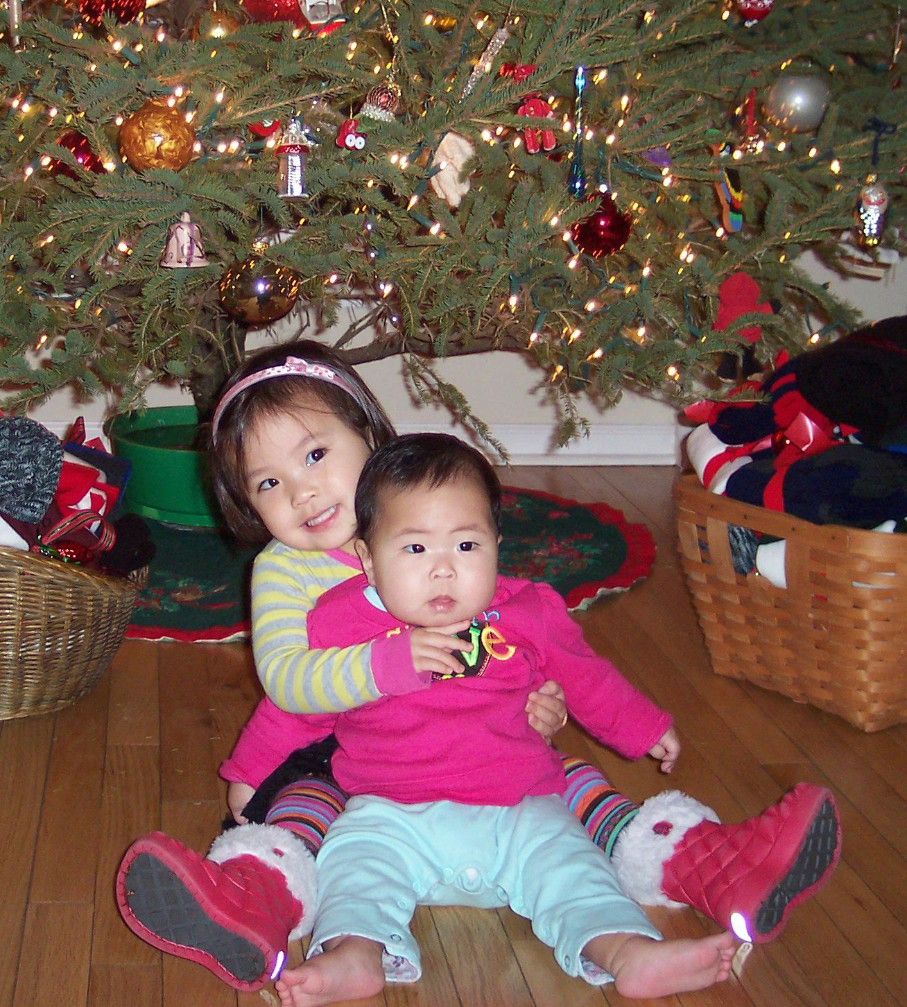 sisters in front of the christmas tree